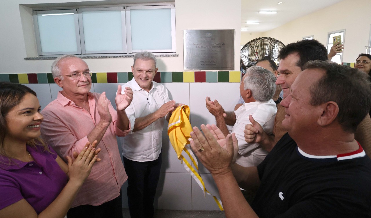 grupo de pessoas posa para a foto durante o descerramento da placa